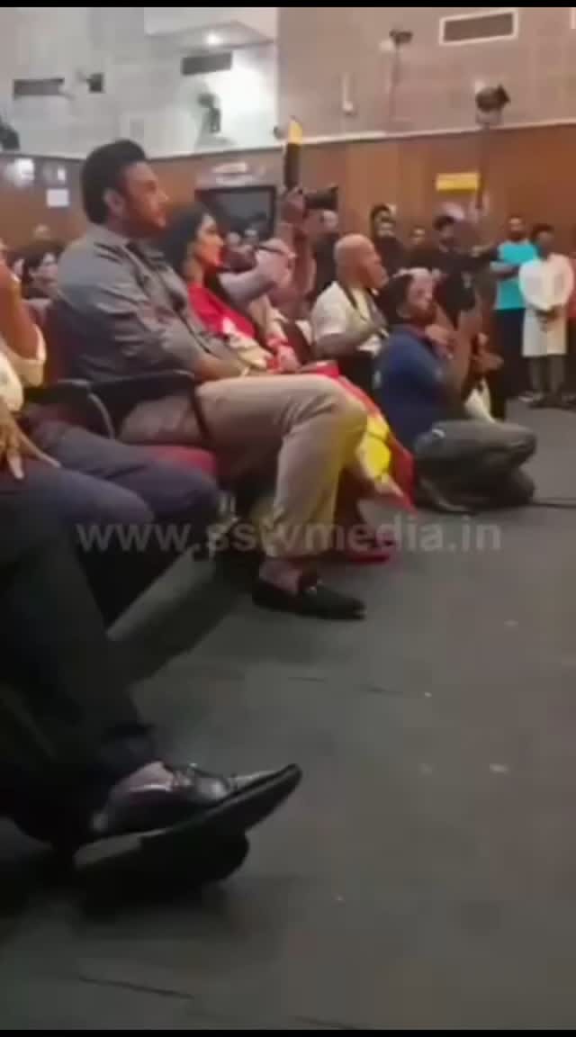 Darshan sits silently watching the dance